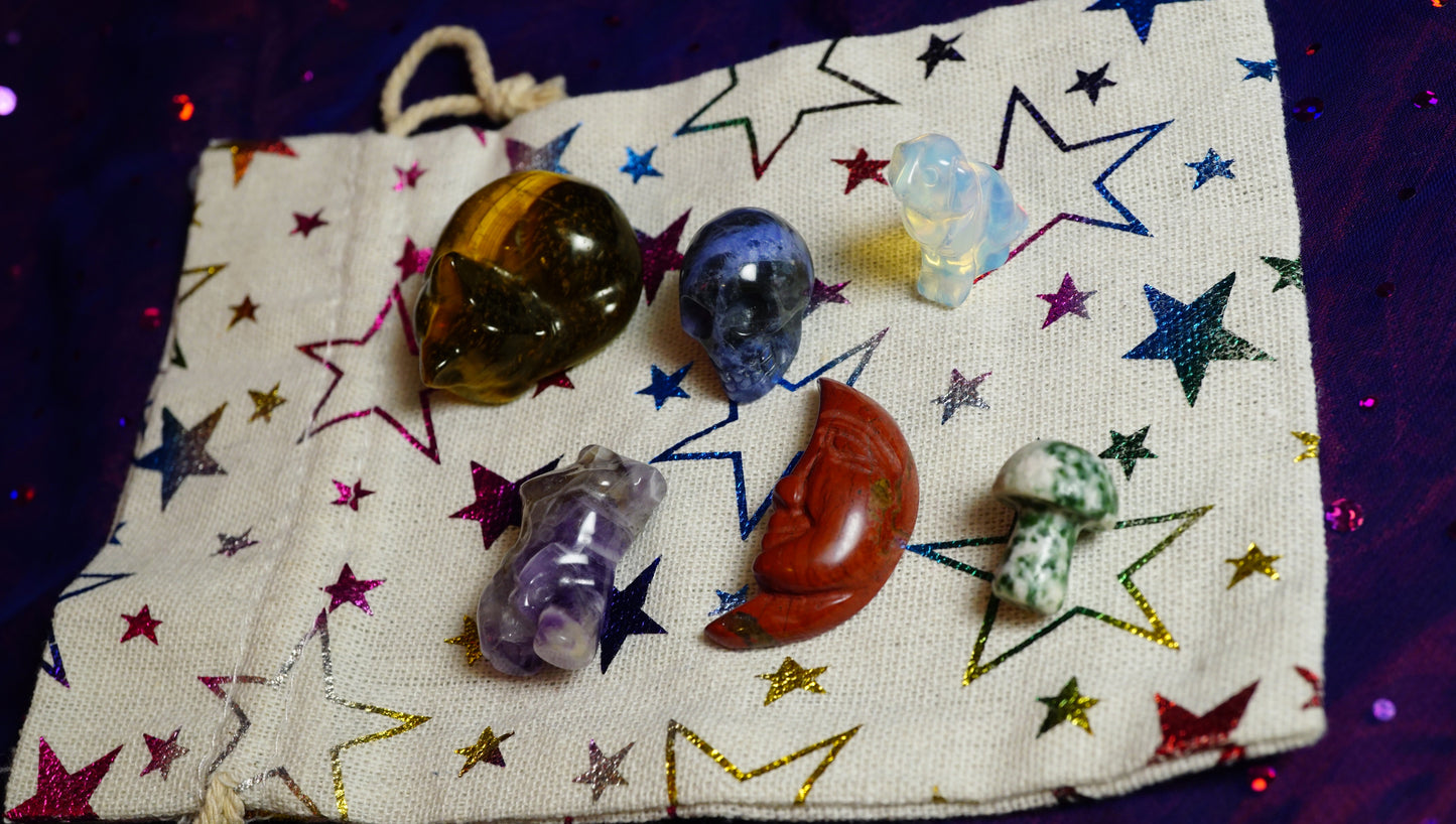 Collection of crystals on a star-patterned cloth with colorful lights in the background