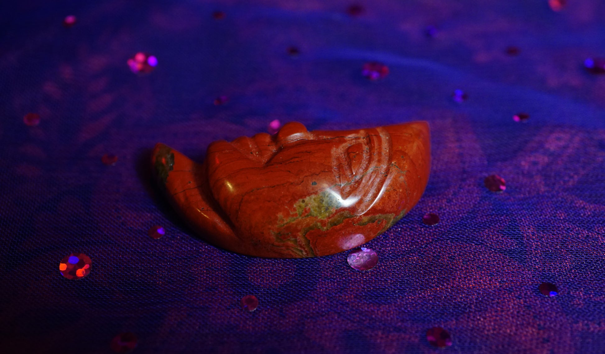 red jasper moon face on purple background