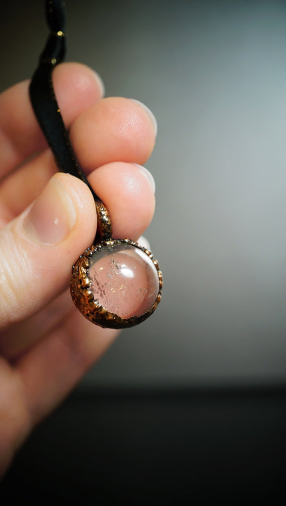 clear crystal ornament in hand with grey  background