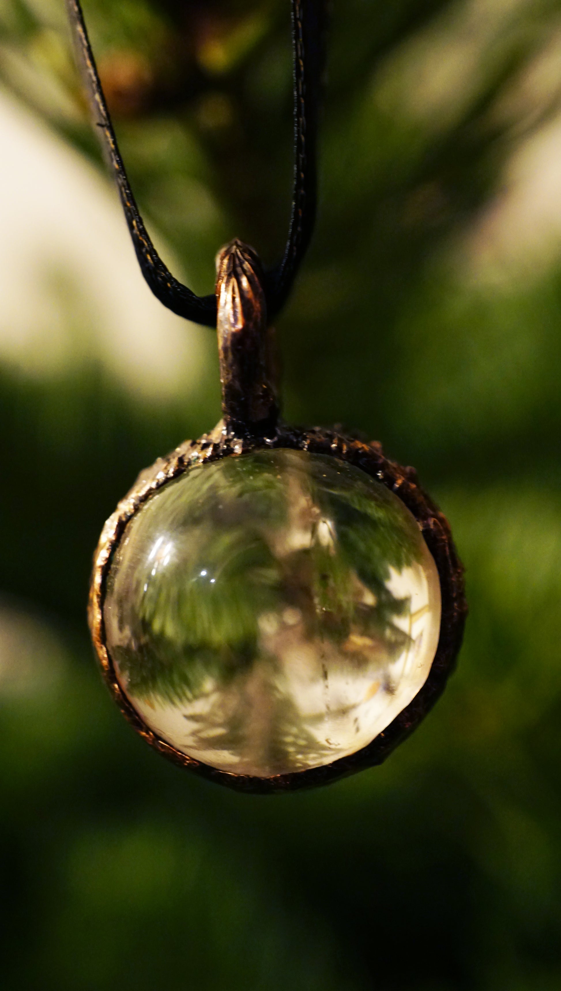 clear quartz ornament against a green christmas tree