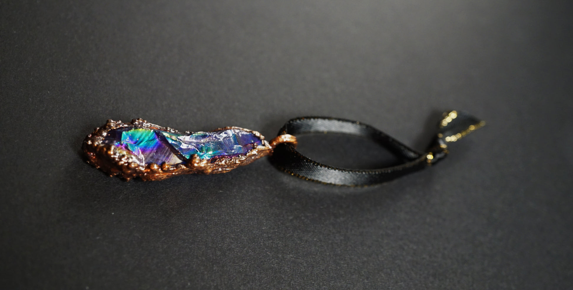 rainbow ornament laying flat on black background