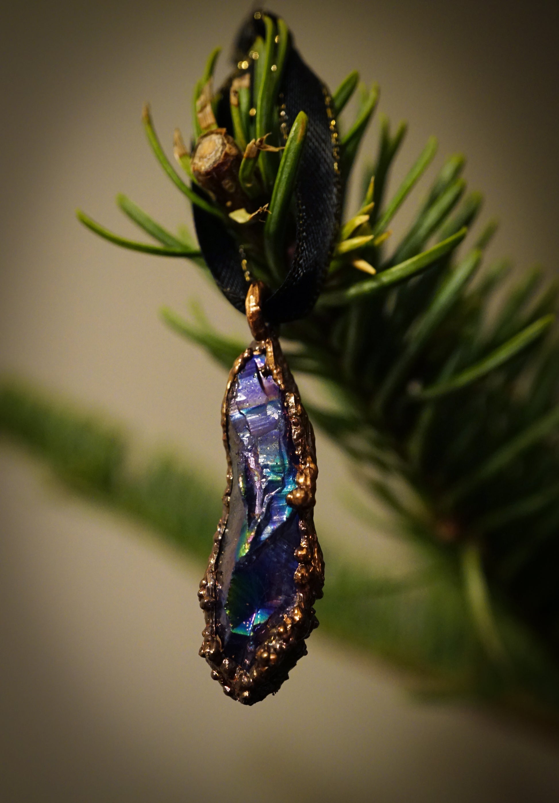 blue and copper ornament hanging from green christmas tree