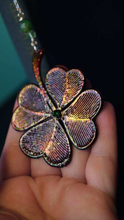 large colorful metallic 4 leaf clover bookmark with green crystal details, in hand