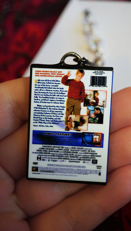 Back of Miniaturized Home Alone DVD case held in a hand with a blurred background
