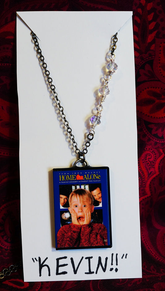 Necklace with a 'Home Alone' pendant on a red patterned background