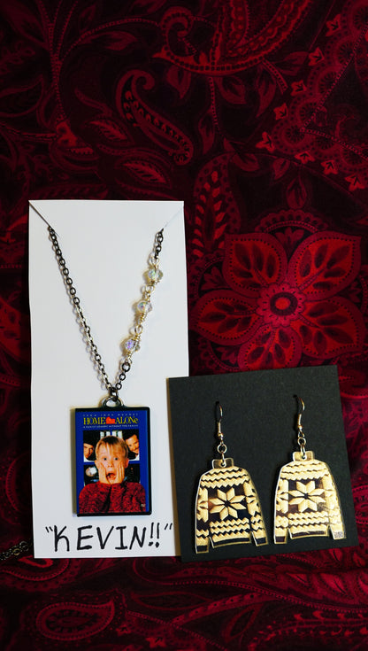 jewelry set with sweater dangles and mini home alone dvd case necklace, on jewelry cards, red background