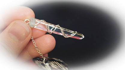 wire wrapped clear quartz in hand