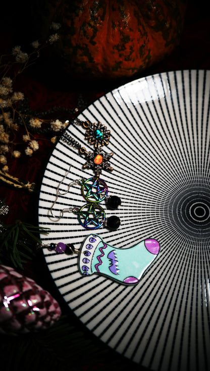 spooky Christmas jewelry displayed together on a black and white beetlejuice-like plate
